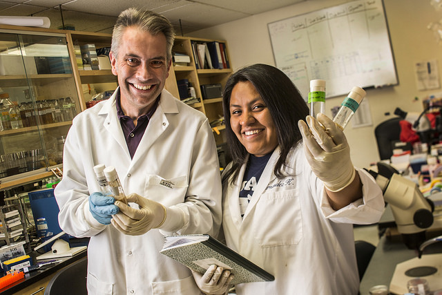 A faculty member and student at a lab